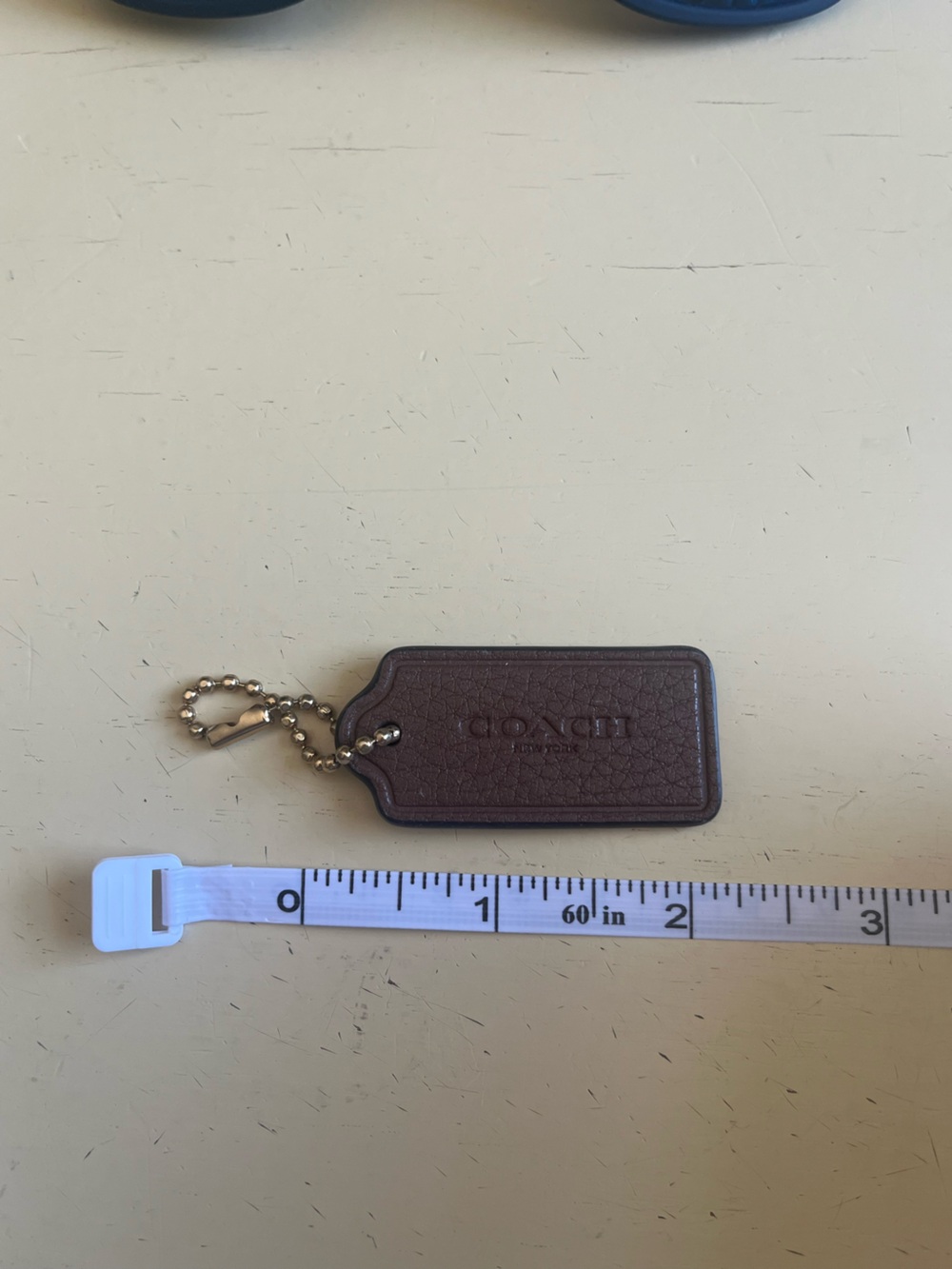 COACH Brown Pebbled Leather Key Tag with Brass Chain
